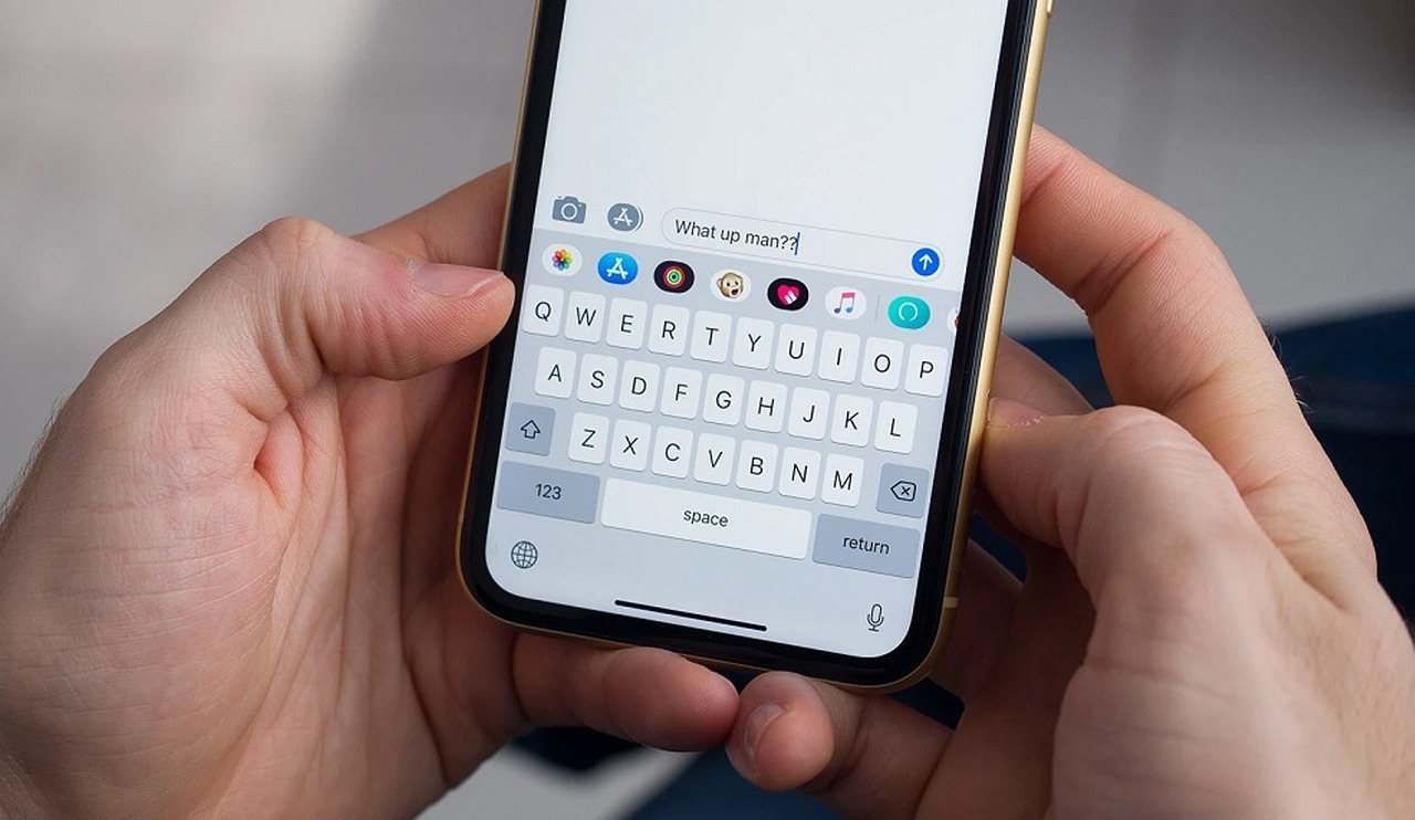 A person typing a message on a smartphone